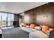 Sleek living room boasts a comfortable sectional sofa, stylish wood paneling, and a city view at 4381 W Flamingo Rd # 3002, Las Vegas, NV 89103
