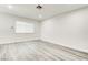 Bedroom with wood-look floors, white walls, and a window bringing in light at 4432 Ash Ave, Las Vegas, NV 89110