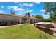 Spacious backyard features a built-in stone grill, green lawn, and covered patio with support columns at 4530 W Shelbourne Ave, Las Vegas, NV 89139