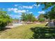 Green backyard featuring a fenced swimming pool, mature trees, and spacious lawn area for outdoor enjoyment at 4530 W Shelbourne Ave, Las Vegas, NV 89139