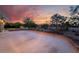 Large backyard features a concrete patio perfect for entertaining near lush landscaping and mature trees at 4530 W Shelbourne Ave, Las Vegas, NV 89139