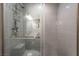 Bathroom shower featuring gray subway tile and sliding glass door with bronze handle at 4530 W Shelbourne Ave, Las Vegas, NV 89139