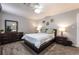 Bedroom with a dresser, night stands, lamps, and flower decorations on the walls at 4530 W Shelbourne Ave, Las Vegas, NV 89139