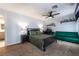This bedroom features neutral colored walls, carpet, a green couch, and a computer at 4530 W Shelbourne Ave, Las Vegas, NV 89139