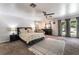 Spacious bedroom with large rug, a bed with decorative pillows, and natural light at 4530 W Shelbourne Ave, Las Vegas, NV 89139