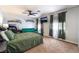 This bedroom has neutral walls, a ceiling fan, a flat screen tv, and a green couch at 4530 W Shelbourne Ave, Las Vegas, NV 89139