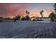 Inviting single-story home featuring desert landscaping and a wide driveway, set against a vibrant sunset backdrop at 4530 W Shelbourne Ave, Las Vegas, NV 89139