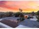 Southwest-style home with desert landscaping, a circular driveway, and an illuminated entrance at 4530 W Shelbourne Ave, Las Vegas, NV 89139