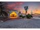 Charming single-story home with a stone facade entrance and inviting porch lighting at 4530 W Shelbourne Ave, Las Vegas, NV 89139
