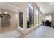 Bright hallway features unique rock wall and access to other rooms; with neutral tile floors and natural light at 4530 W Shelbourne Ave, Las Vegas, NV 89139
