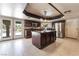 Well-equipped kitchen with a center island, stainless steel appliances, and access to the backyard through glass doors at 4530 W Shelbourne Ave, Las Vegas, NV 89139