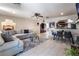 Open-concept living room with sectional sofa, dining area, and kitchen view; featuring stylish decor and ample space at 4530 W Shelbourne Ave, Las Vegas, NV 89139