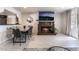 Modern living room with a marble fireplace, a wall-mounted TV, and an adjacent dining area with seating at 4530 W Shelbourne Ave, Las Vegas, NV 89139