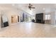 Bright living room with large windows, a unique rock wall, and tile flooring throughout at 4530 W Shelbourne Ave, Las Vegas, NV 89139