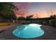 Backyard pool reflects the vibrant colors of the evening sky, creating a serene oasis at 4530 W Shelbourne Ave, Las Vegas, NV 89139