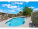 Backyard pool with a tanning shelf and fenced in yard under a blue sky at 4530 W Shelbourne Ave, Las Vegas, NV 89139