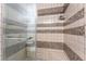 Tiled shower with glass door and built in bench at 4530 W Shelbourne Ave, Las Vegas, NV 89139