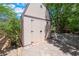Backyard features a shed with double doors and a small patio with greenery surrounding the area at 4530 W Shelbourne Ave, Las Vegas, NV 89139
