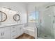 Bright bathroom featuring double sinks, wood-look tile floors, a soaking tub, and a glass-enclosed shower at 5228 Shasta Lake Way, Las Vegas, NV 89118