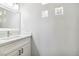 Bathroom featuring a modern vanity with solid surface counter and unique mirror at 5228 Shasta Lake Way, Las Vegas, NV 89118