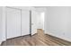 Neutral bedroom with wood-look flooring, closet, and a doorway to another room at 5228 Shasta Lake Way, Las Vegas, NV 89118