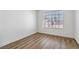 Bright, empty bedroom with wood-look flooring, a large window, and neutral colored walls at 5228 Shasta Lake Way, Las Vegas, NV 89118