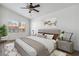 A staged bedroom featuring a neutral color palette, ceiling fan and updated flooring at 5228 Shasta Lake Way, Las Vegas, NV 89118
