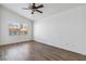Empty bedroom featuring a ceiling fan, luxury vinyl flooring and a large window at 5228 Shasta Lake Way, Las Vegas, NV 89118