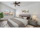 Bright bedroom featuring a ceiling fan, neutral decor, and a large window offering natural light at 5228 Shasta Lake Way, Las Vegas, NV 89118