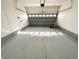 Clean, empty garage with epoxy flooring and an automatic door at 5228 Shasta Lake Way, Las Vegas, NV 89118