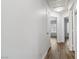 Hallway with doors leading to various rooms, featuring modern wood-look flooring and neutral paint at 5228 Shasta Lake Way, Las Vegas, NV 89118