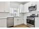 Modern kitchen featuring white cabinets, stainless steel appliances, and quartz countertops at 5228 Shasta Lake Way, Las Vegas, NV 89118