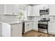 A well-lit kitchen features white cabinetry, quartz countertops, and stainless steel appliances at 5228 Shasta Lake Way, Las Vegas, NV 89118