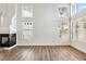 A bright, empty living room with modern flooring, and large windows at 5228 Shasta Lake Way, Las Vegas, NV 89118