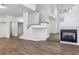 Spacious living area with a fireplace, hardwood floors, and a staircase at 5228 Shasta Lake Way, Las Vegas, NV 89118