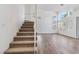 Carpeted staircase with white railing and modern flooring on the lower level at 5228 Shasta Lake Way, Las Vegas, NV 89118