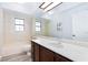 Clean bathroom featuring a tub/shower combination, vanity with marble countertop, and a skylight at 5601 Cavalier Cir, Las Vegas, NV 89130