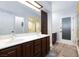 Bathroom featuring double sinks, framed mirror, wood look floors and walk-in shower at 5601 Cavalier Cir, Las Vegas, NV 89130