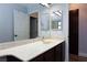Bathroom with vanity, marble countertop, large mirror, and dark wood cabinets at 5601 Cavalier Cir, Las Vegas, NV 89130