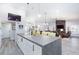 Open-concept kitchen featuring a large island that overlooks the living area and fireplace at 5601 Cavalier Cir, Las Vegas, NV 89130
