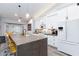 Bright kitchen with a large island, white cabinets, stainless steel appliances, and modern lighting at 5601 Cavalier Cir, Las Vegas, NV 89130