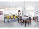 Bright, open-concept dining and kitchen area with seating at the counter and updated decor throughout at 5601 Cavalier Cir, Las Vegas, NV 89130