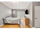 Simple bedroom with wood floors, gray walls, sliding glass doors, and television at 5855 Valley Dr # 1080, North Las Vegas, NV 89031