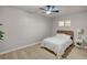 Bright bedroom with laminate floors, a modern ceiling fan, a full-sized bed, and a nightstand at 700 Cactus Ln, Las Vegas, NV 89107