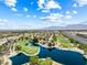 Scenic aerial view of a lush golf course community with a serene lake and well-manicured greens at 7241 Indian Creek Ln # 203, Las Vegas, NV 89149