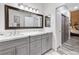 Bathroom featuring double sink vanity with gray cabinets and a large mirror at 7241 Indian Creek Ln # 203, Las Vegas, NV 89149