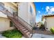 Exterior staircase and second-story entrance to condos with manicured landscaping at 7241 Indian Creek Ln # 203, Las Vegas, NV 89149