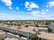 Charming townhomes with tile roofs and well-maintained landscaping under a bright, cloud-filled sky at 7241 Indian Creek Ln # 203, Las Vegas, NV 89149