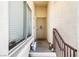 Inviting front porch with security door, small garden bench, and seasonal decorations at 7241 Indian Creek Ln # 203, Las Vegas, NV 89149