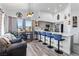 Modern kitchen with stainless steel appliances and bar stool seating facing the living area with mountain views at 7241 Indian Creek Ln # 203, Las Vegas, NV 89149